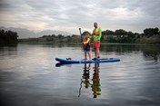 father-and-his-son-are-standing-on-the-sup-board-2022-11-10-18-24-09-utc